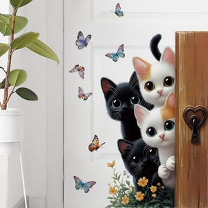 Detail showing 3D cartoon cats and colorful butterflies stickers on a white door
