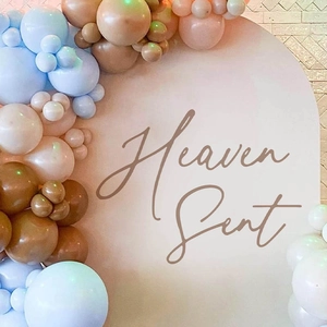 Heaven Sent party arch wall sticker with blue, beige, and brown balloon garland set