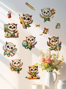 Detailed view of cartoon owl wall stickers with books and pencils in a classroom theme