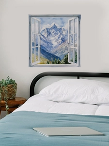 Detail of 3D window wall decal showing a snowy mountain and forest in a bedroom setting
