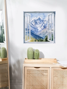 Close-up of 3D window wall decal featuring snowy mountain scenery and pine forest view