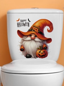 Detail of Halloween gnome sticker with pumpkin and bat motifs on white toilet tank
