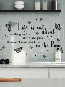 Detail of inspirational life quotes and black butterflies wall stickers on marble wall