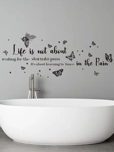 Detail of inspirational vinyl wall sticker with butterflies and stars on a gray wall