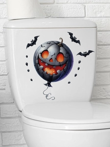 Detail of Halloween pumpkin decal and bat stickers on a white ceramic toilet tank