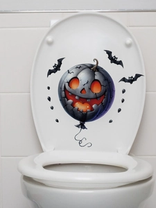 Detail of Halloween pumpkin toilet sticker with glowing eyes and flying bats decoration