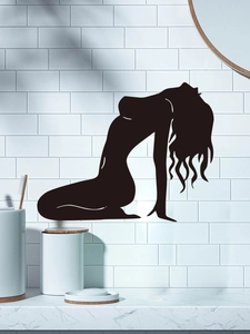 Detail of female silhouette wall decal applied on white tiles in a modern bathroom