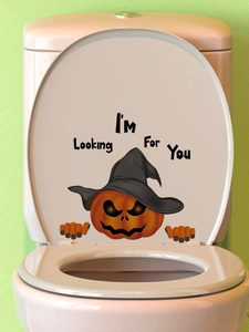 Close-up of Halloween pumpkin sticker with witch hat on toilet lid for home decor