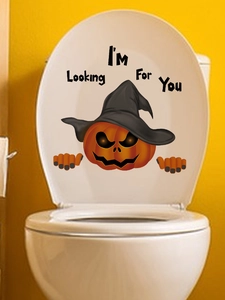 Detail view of pumpkin toilet sticker with 'I'M Looking For You' text on a white lid