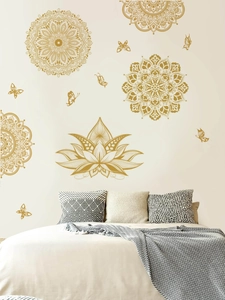 Detail of golden mandala and lotus wall stickers with butterflies in a bedroom setting