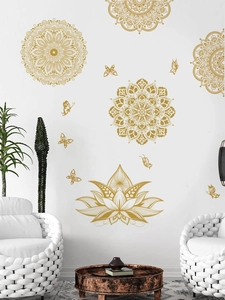 Detailed view of golden mandala and butterfly wall decals on a minimalist white living room wall
