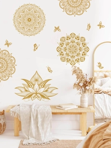 Golden mandala wall decals and butterflies above a wooden bench in a cozy living room