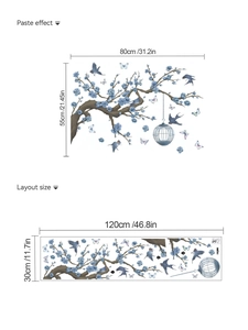 Detail of floral wall sticker layout and paste effect showing blue blossoms and birds