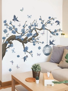 Detailed wall sticker featuring blue flowers, birds and cage on a living room wall