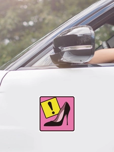 Detail of a pink self-adhesive high heel wall sticker applied on a white surface