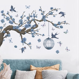 Blue floral branches with birds and hanging birdcage wall decal over a blue sofa