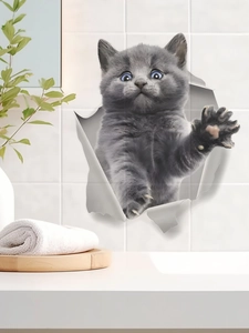 Sticker mural 3D représentant un chaton gris mignon sortant d'un mur brisé