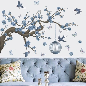 Artistic wall sticker featuring blue flower branches, birds, and birdcage for home decor