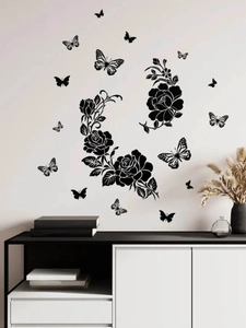 Detail of black rose and butterfly wall decals on a clean white living room wall