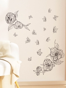 Detail of black line art flower wall stickers showing peony pattern in living room