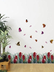 Detail of floral butterfly wall stickers showing watercolor flowers on a white living room wall