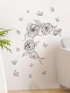 Detailed view of black and white floral wall stickers with butterflies in a modern living room