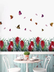 Detail view of red flower bushes and colorful butterfly wall stickers in a dining room