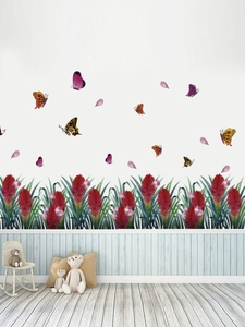 Detail showing colorful butterflies and red tropical flower wall stickers in a nursery room