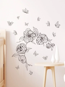 Modern black flower and butterfly wall stickers applied on a clean white living room wall