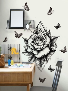 Detail of black rose wall sticker with butterflies and geometric patterns on a white wall