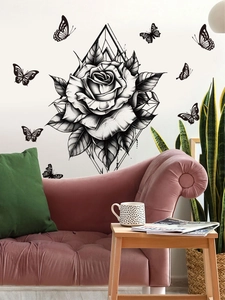 Detail of elegant black rose wall sticker with butterflies in a modern living room setup