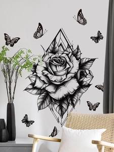 Detail of black rose wall sticker with butterflies and geometric lines in a living room