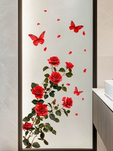 Detail of red rose and butterfly wall stickers on a frosted glass bathroom door