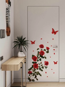Detail of red rose and butterfly PVC wall stickers on a modern white interior door