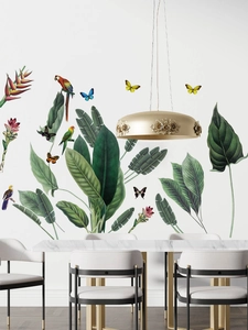 Detail of tropical green plant wall stickers with colorful parrots and butterflies design