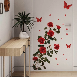 Self-adhesive red rose and butterfly wall stickers applied on a white interior door
