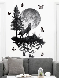 Detail showing howling wolf and pine tree wall sticker on a white wall above a sofa