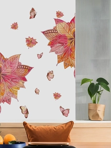 Close-up of red mandala floral wall sticker and butterflies on a white home wall