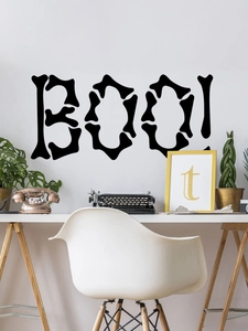 Detail of BOO Halloween wall sticker with bone shaped letters on white home wall
