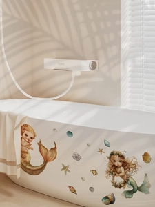 Detail of cartoon mermaid stickers on a bathtub with shells and starfish marine elements