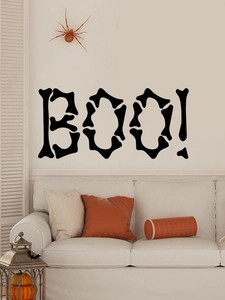 Detail of BOO! Halloween wall sticker in bone-style font on a living room wall