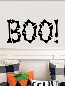 Detail of Halloween BOO wall sticker with bone-shaped letters on a white bedroom wall