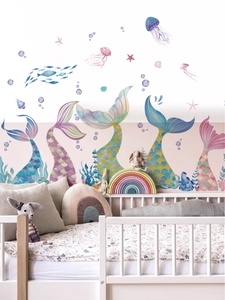 Detail view of watercolor mermaid tails and jellyfish wall stickers in a child's bedroom