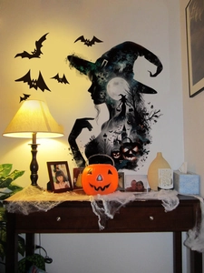 Halloween witch silhouette wall decal with bats, moon and castle motifs on a living room wall