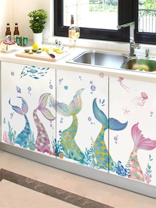 Detail of waterproof mermaid tail wall decals applied to white kitchen cabinets decor