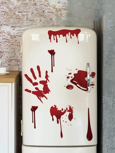 Detailed view of bloody handprint and blood drip stickers on a vintage refrigerator