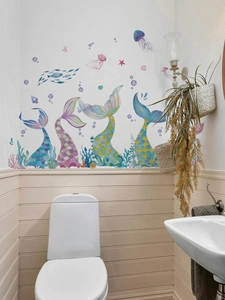 Detail view of watercolor mermaid tails with jellyfish and coral wall decals in a bathroom