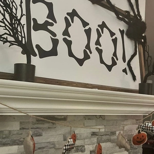 Halloween BOO skeleton wall art with black withered trees and festive spider decorations