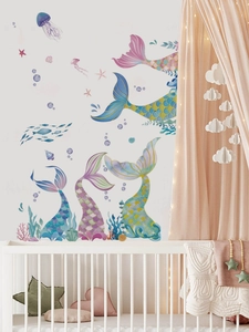 Detailed watercolor mermaid tail stickers with colorful scales on a white bedroom wall