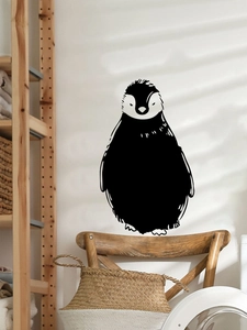 Minimalist black penguin wall sticker displayed in a cozy Nordic style living room scene